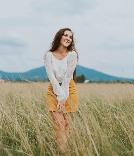Happy woman in a green wheat field